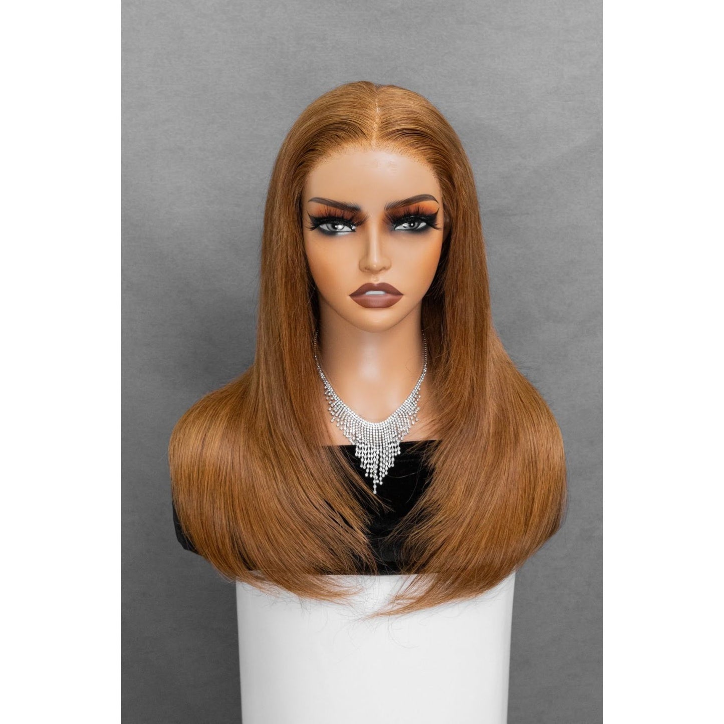 Layered straight glueless wig with honey brown tones and 180% natural density.